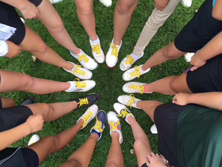 Athletes, students replace laces for Cancer Awareness