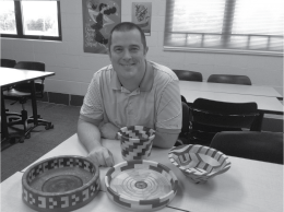 Math teacher Bob Pinta surrounded by his wooden creations. Pin- ta gives woodworking tutorials on his youtube channel, Bob Pinta.