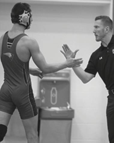 Nikita Nepomnyashchiy and Coach Cook high five after Nepomnyashchiy picks up another win.