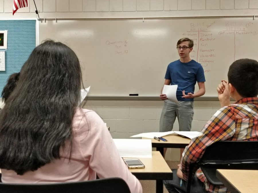 An Aptakisic student gives a speech during the middle school debate tournament while other students prepare to ask questions on May 2nd.  Aptakisic went on to win the tournament for the fifth year in a row.