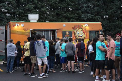 Students line up in front of Cheesie’s food truck. Streetfest had a variety of food available including tacos, soul food, and bundt cakes.
