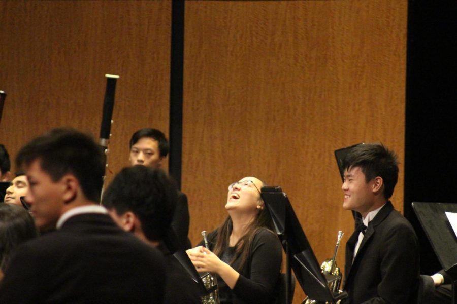 Miriam SIlberman 19 laughs during a break in the performance. Silberman is a member of band, but performed with Patriot Orchestra during the concert. 