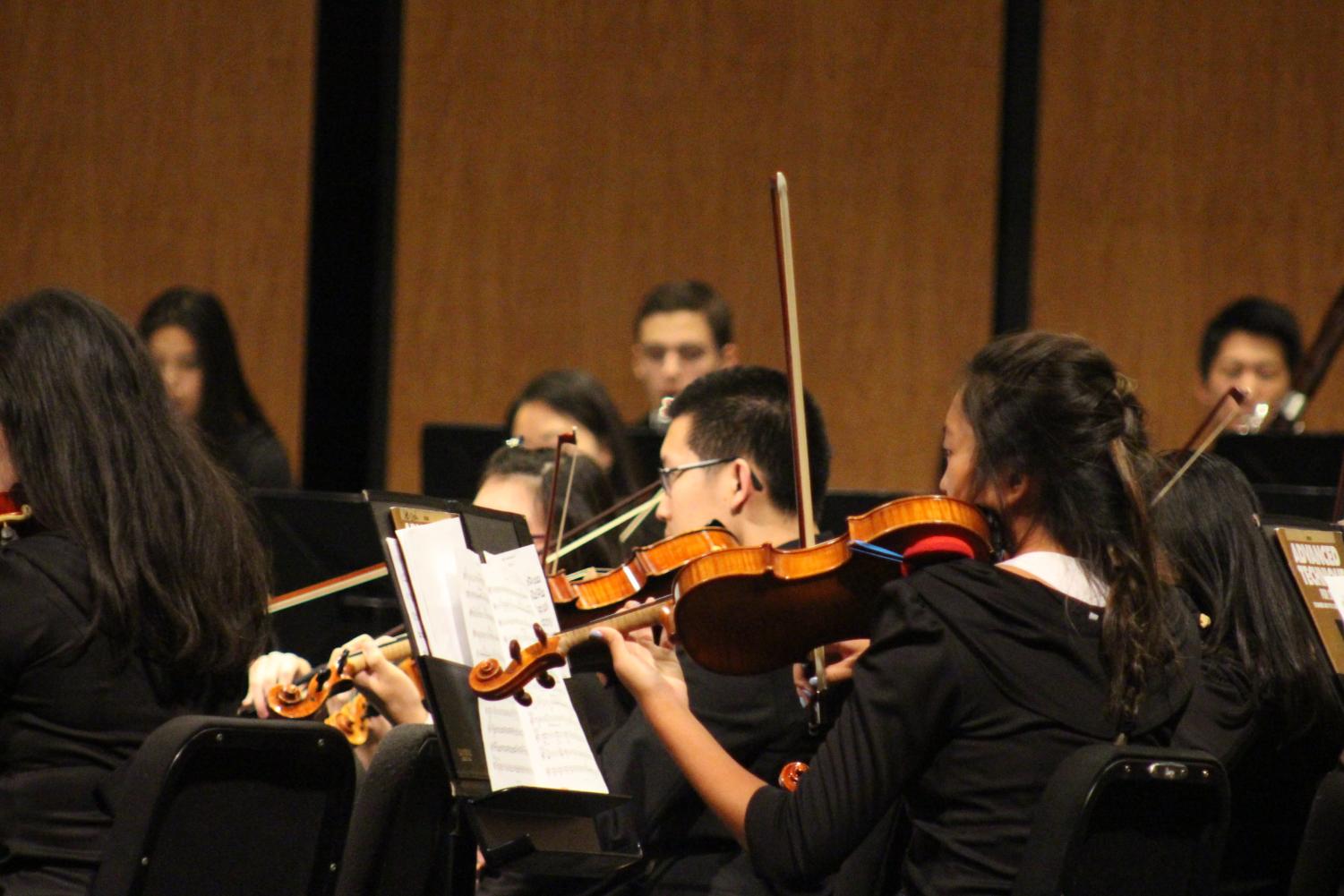 Adele Lee '19 and and Andrew Ding '19 perform during the fall orchestra concert. Lee and Ding are members of Patriot Orchestra.