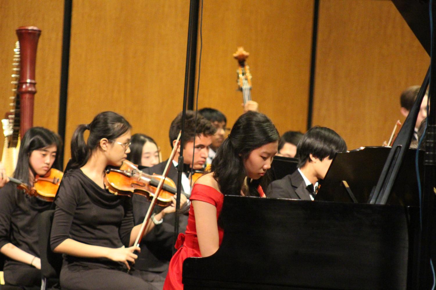 Stephanie Li '19 performs a piano concerto while the rest of Patriot Orchestra plays along. Future soloists will include Adele Lee '19 and Reid Harmon '19.