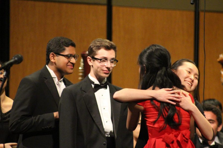 Erin Yuan 20, Sam Wachtel 19, and Achuth Raghunath 19 line up to congratulate Stephanie Li 19. Li was the soloist for the concert and performed Ravels Piano Concerto in G Major, Movement No. 1