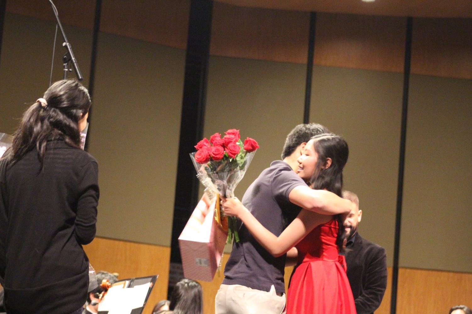 Michael Hu '19 congratulates Stephenie Li '19 on her performance. Li was the soloist, and performed Ravel's Piano Concerto in G Major, Movement No. 1