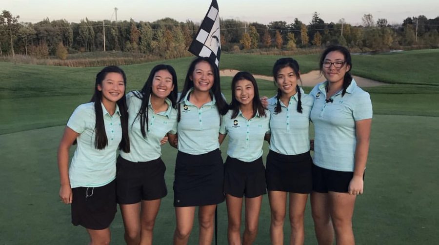 Joyce Bai 20 (Right) stands proudly with the girls varsity golf team after winning 3rd place at the Huntley Sectional. The team is now headed to state.
