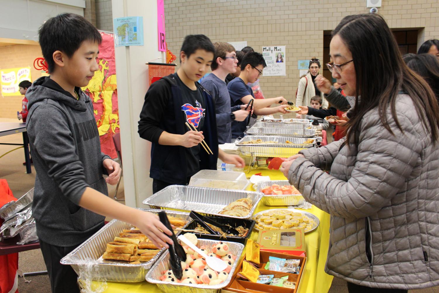 Andrew Wang '22 and other enthusiastic Chinese club volunteers served homemade Chinese food in exchange for tickets.  Spring rolls, bao zi, and scallion pancakes were all part of their authentic cuisine, which attending families and students enjoyed.