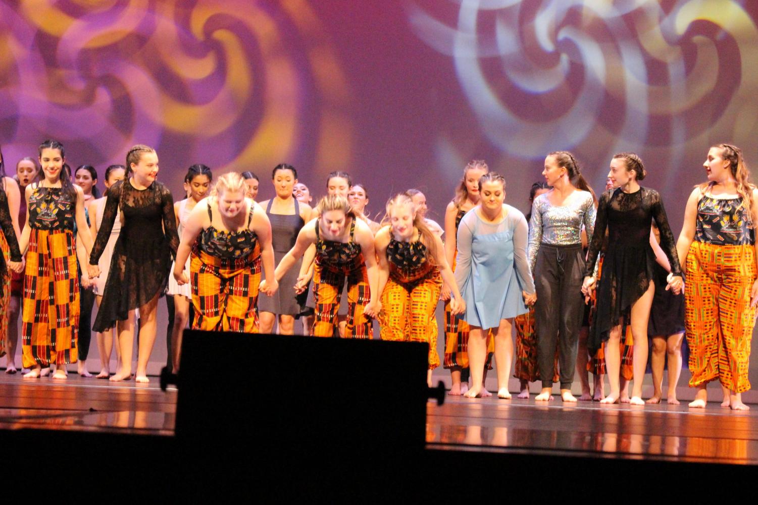 The concert comes to an end. Dancers bow on stage.