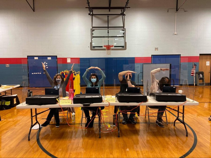Mikayla Varghese ’21 (far right) and other election judges show their enthusiasm on the job. Even though their job lasts many hours on Election Day, election judges are excited to take on the challenge. Courtesy of Varghese.