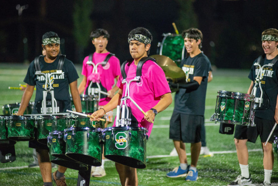Ryan Arceo ’23 leads the drumline with his marching tenor drums during the band’s performance on the football field. Streetfest attendees filled the bleachers to watch and listen to performances like the drumline’s show.