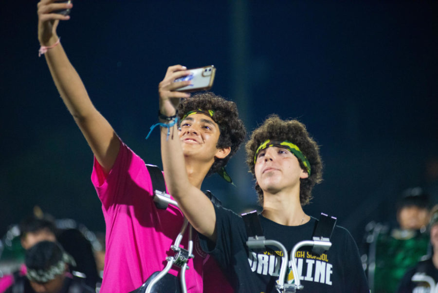 Drumline percussionists take a selfie in front of the student bleachers after completing their Streetfest performance. They are part of several student groups who performed during the closing assembly.