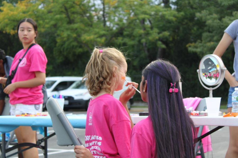 Iman Qazi '24 paints faces at her Streetfest booth. Face painting was one of many fun and memorable experiences attendees could take part in at Streetfest.