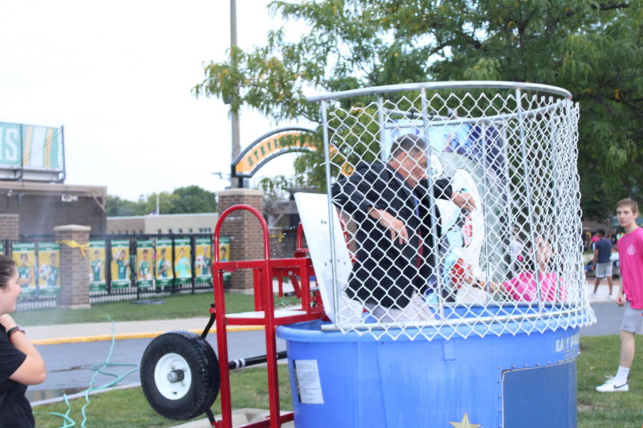 Principal Troy Gobble takes a plunge in the Catalyst dunk tank courtesy of student participation. The prospect of dunking Principal Gobble and other Catalyst members was an alluring part of Catalyst's booth which connected having fun and spreading awareness about substance abuse.