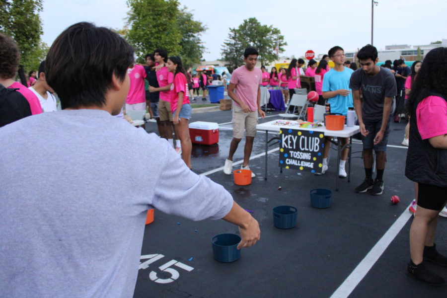 Students visiting the Key Club booth participate in a fun tossing challenge. Many clubs at Streetfest featured booths with games and prizes ranging from souvenirs to drenching student leaders with water balloons.