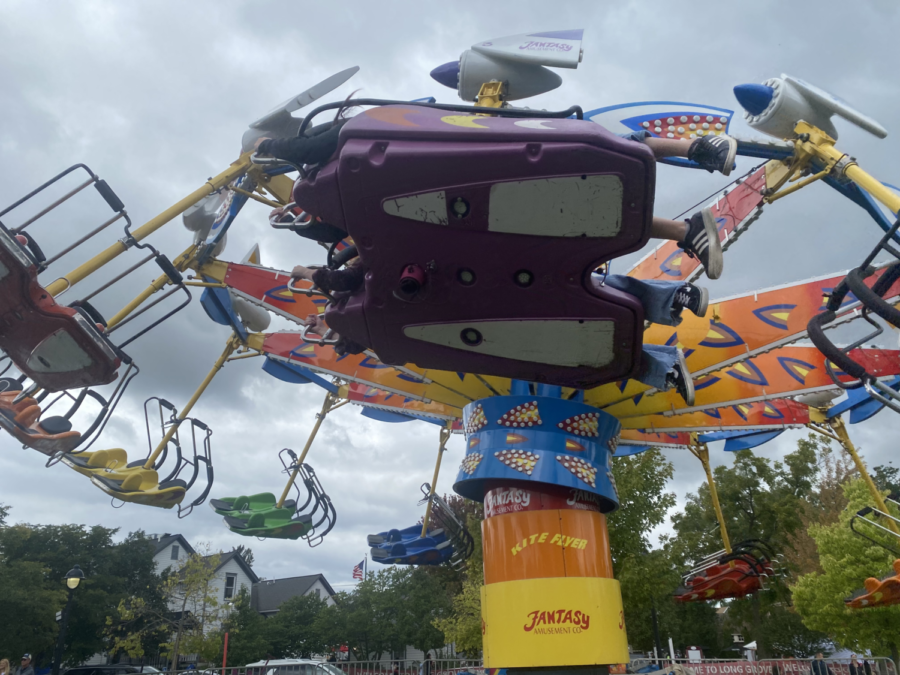 A group of children ride the “Superman” attraction in the event’s carnival section.  Other attractions at the event included a pumpkin painting activity and a mini Ferris wheel.