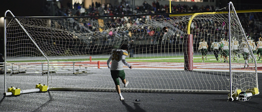 Kicker Caden An ’26 utilizes the Zion-Benton soccer net to practice his kicking during halftime. An connected on 4 out of 5 extra points and has secured an extra point success rate of 95 percent for the season.