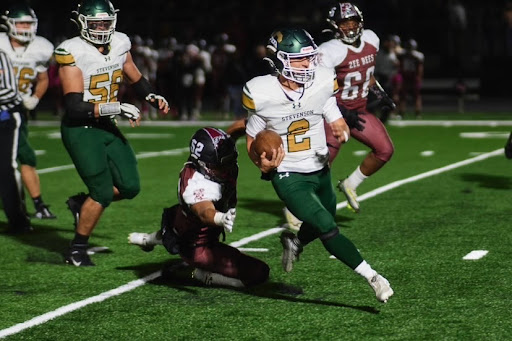 Quarterback Matt Projansky ’23 avoids a Zion-Benton defender on a designed quarterback run. Projansky finished the game with two rushing touchdowns.