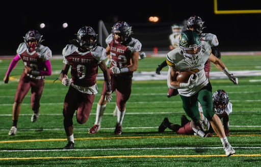 Running back Michael Maloney ’23 races past multiple Zion-Benton defenders to score a touchdown. Maloney’s touchdown increased his season total to eight.