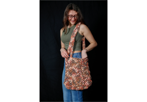 Christina Santello ’23 models her crochet handbag. Santello started selling her crochet items after interest from her friends.