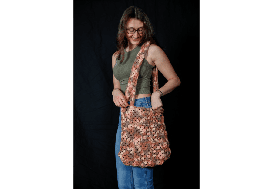 Christina Santello ’23 models her crochet handbag. Santello started selling her crochet items after interest from her friends.