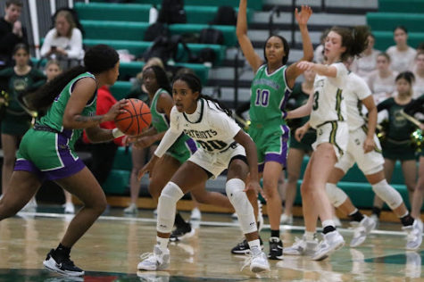 Guard Kendell Williams ’24 and Kate Arne ’23 defend the pick and roll offense of Waukegan. Stevenson had a strong defensive performance, holding Waukegan to 6 points in the second half.