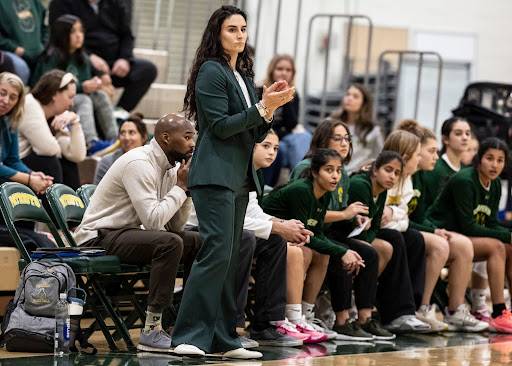 Coach Regan Carmichael, staff, and players’ bench on-look a play against New Trier.  The new season is filled with optimism and new beginnings for the team.