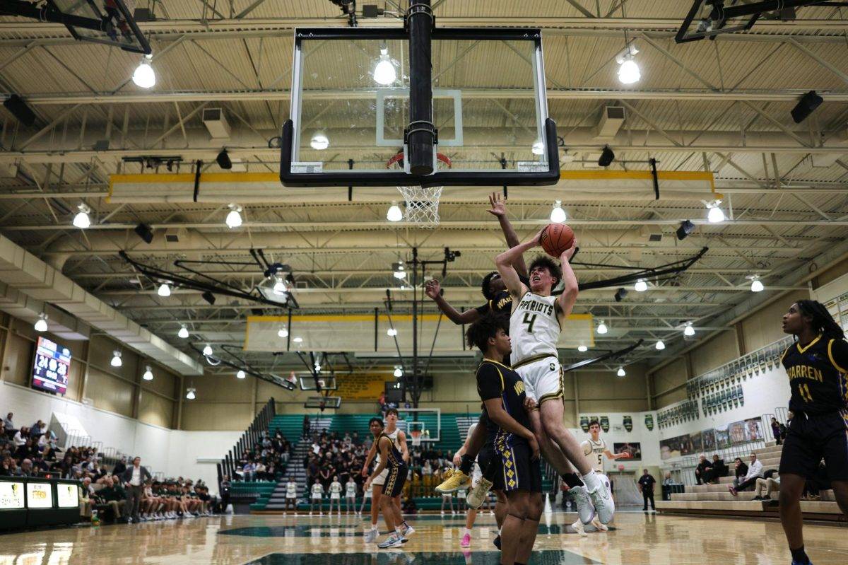 Aiden Bardic '25 drives to the baseline for the layup against the Warren defense. He finished the night with 15 points.