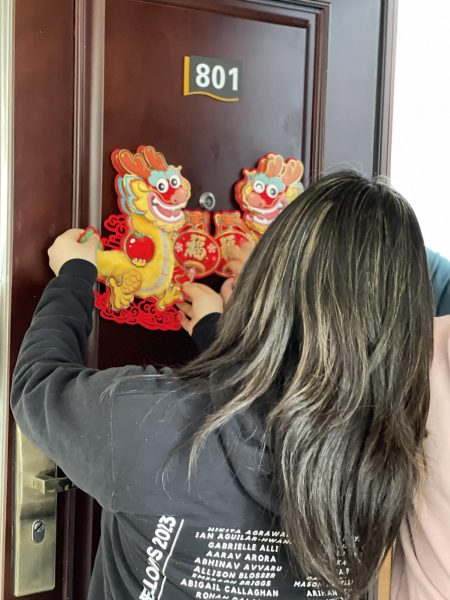 Hanging up dragons for the Year of the Dragon on our main door. One of the many well wishes people say is to hope the Year of the Dragon is as smooth as a dragon flies across the sky.