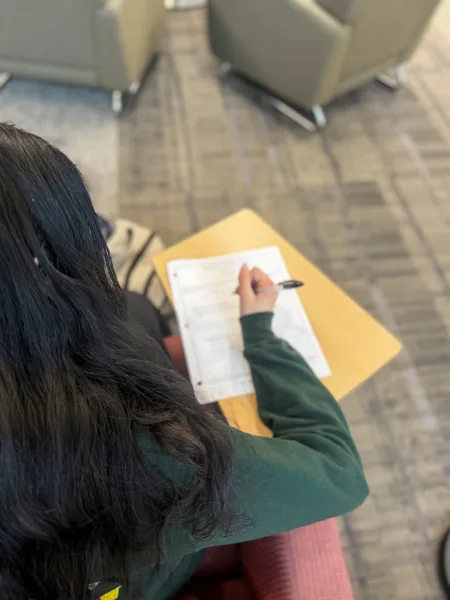 A student in the ILC fills out a written club application. Many clubs use applications in order to determine their executive boards, or admit students to the clubs.