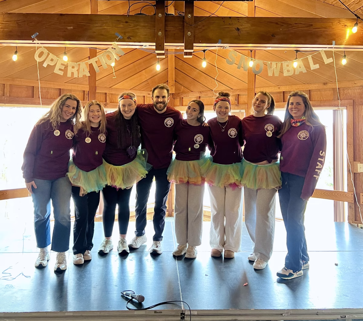 Operation Snowball sponsors and student directors pose inside the winter retreat’s home at Camp Timber-lee in East Troy, Wisconsin. Over the course of three days, Snowball participants were led by staffers in team-building workshops and games, including a pajama party, a Dress to Impress fashion show, improv, and various icebreakers. Photo courtesy of Meredith Steciuk ’26.